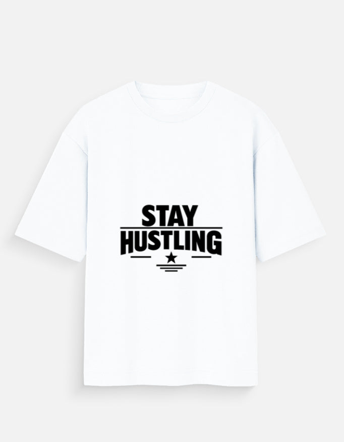 Oversized crew-neck T-shirt in white, short sleeves, front graphic text “STAY HUSTLING”