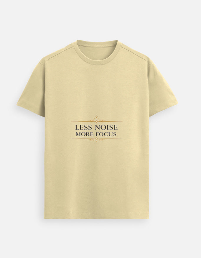 Beige unisex graphic tee with “LESS NOISE MORE FOCUS” text design on chest